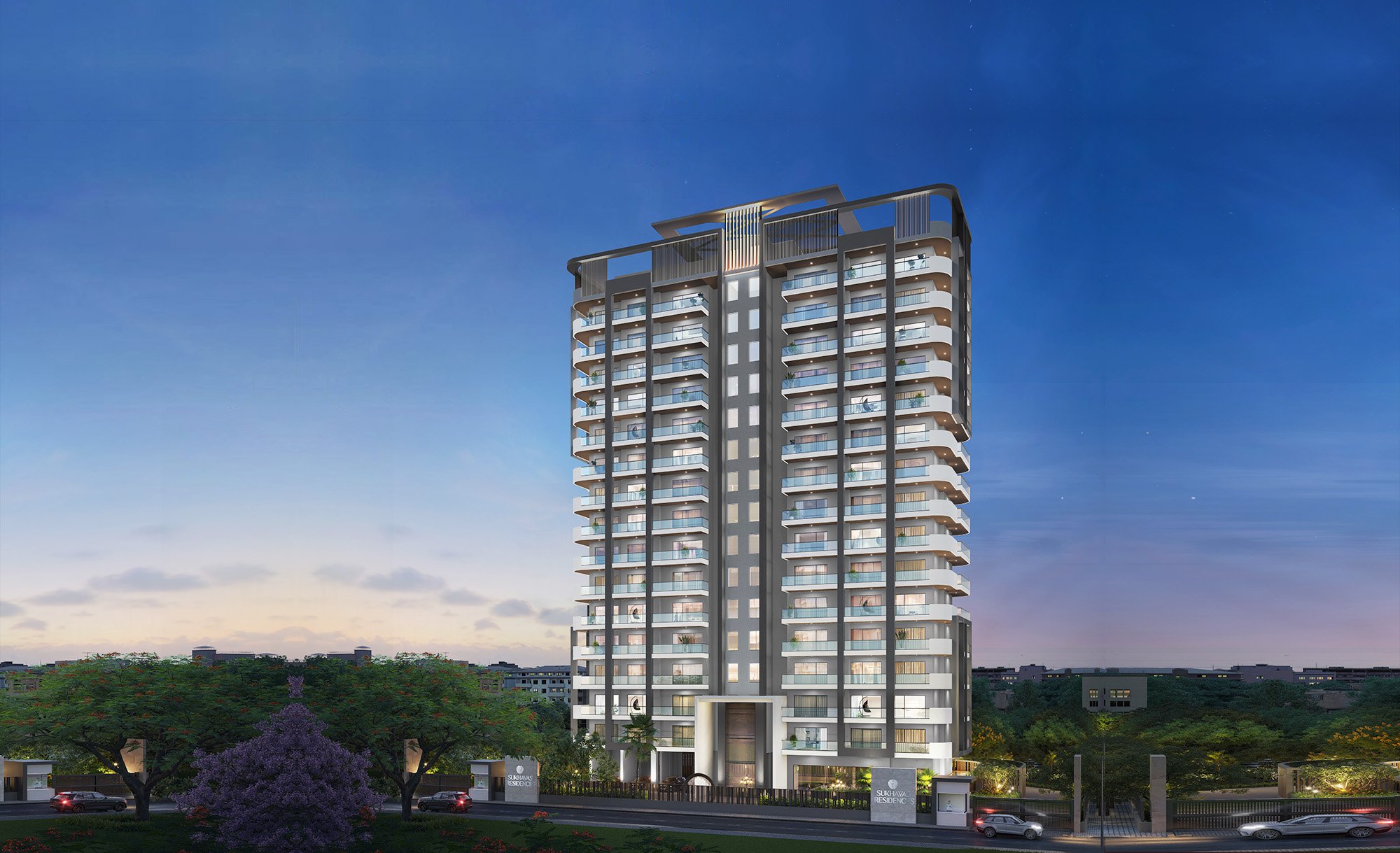 Night view of a modern high-rise residential building with multiple floors and illuminated balconies, surrounded by trees and a street with cars.